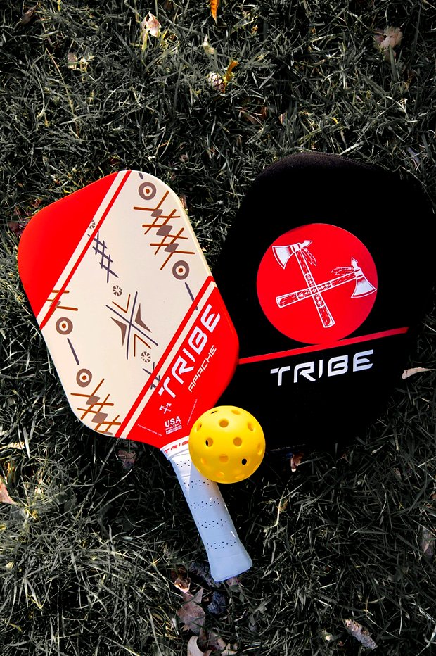 The Apache paddle beside the included TRIBE paddle cover and a pickleball
